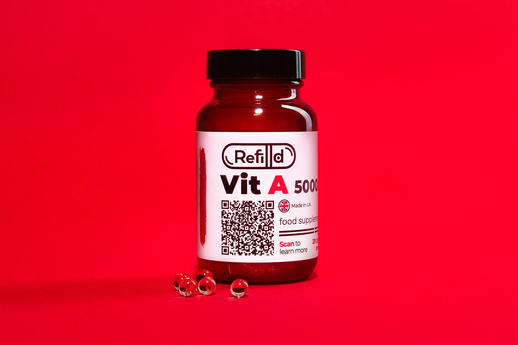 Refilld Vit A 5000 iu food supplement bottle with soft-shell capsules on a red background.
Refilld Vit A, 5000 iu, food supplement, vitamin A, red background