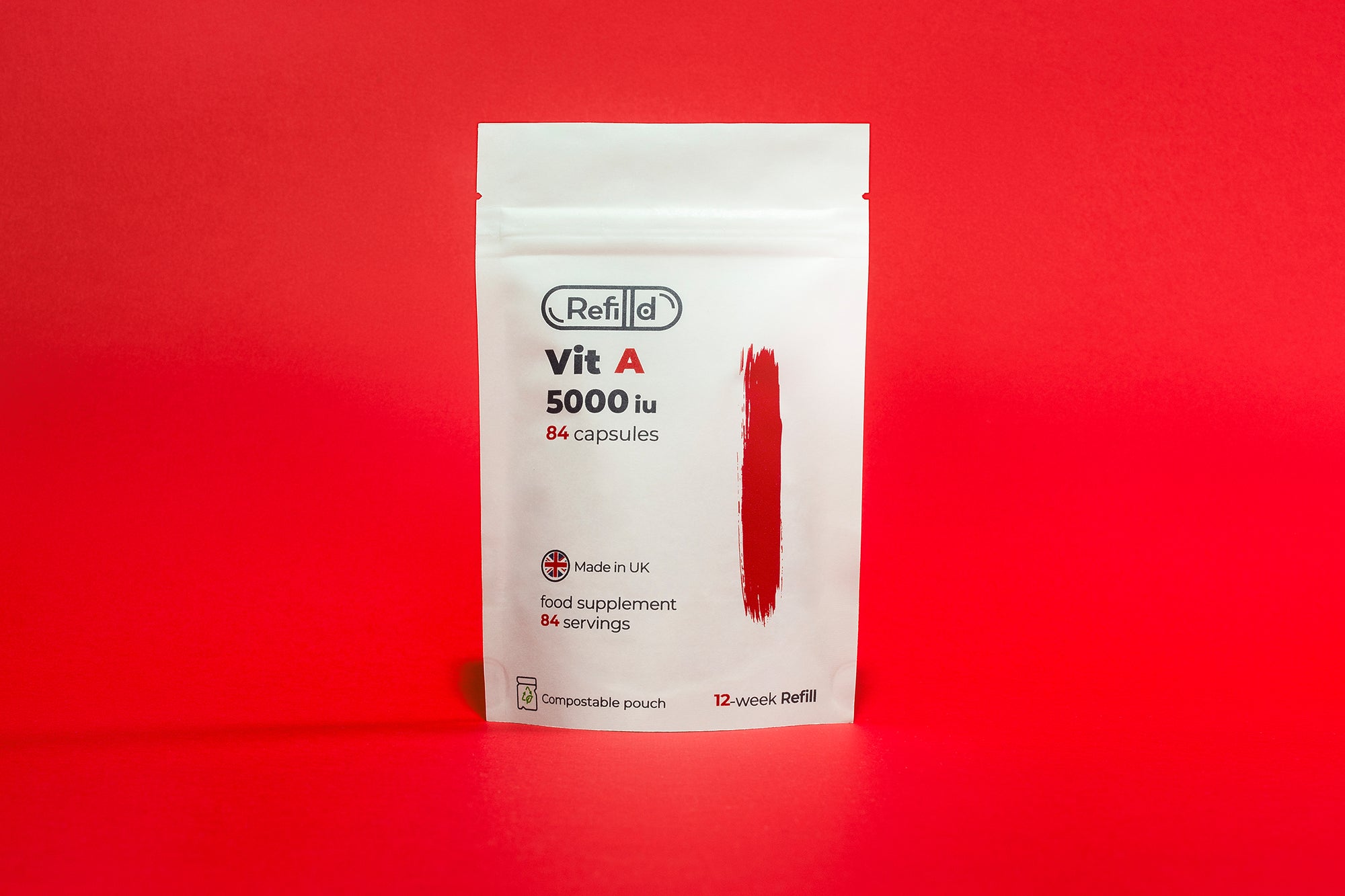 Refilld Vit A 5000 iu compostable refill pouch on a red background.
Refilld Vit A, 5000 iu, compostable refill pouch, eco-friendly packaging, red background