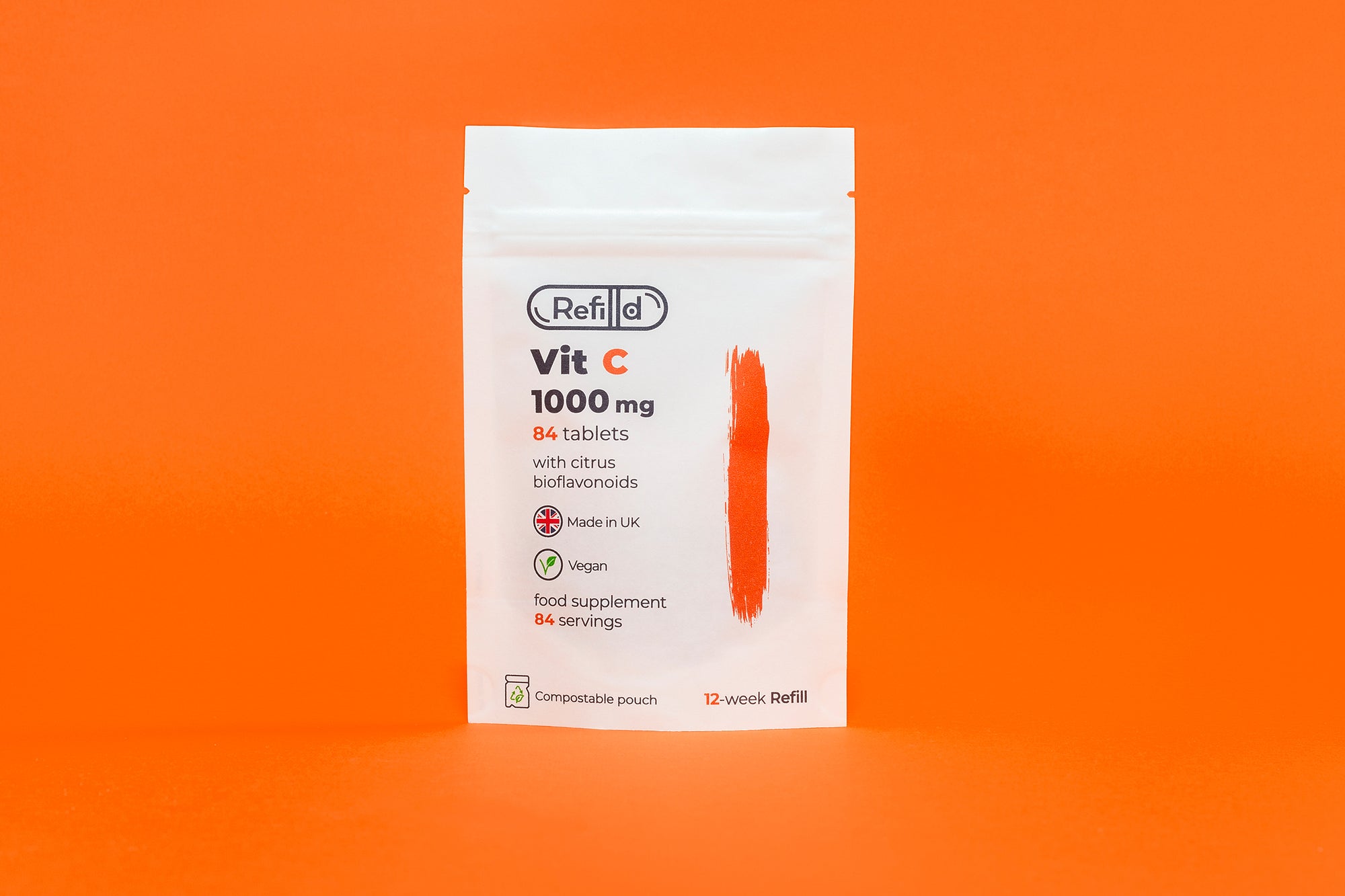 Refilld Vit C 1000 mg compostable refill pouch for a 12-week supply, displayed on an orange background.
Refilld Vit C 1000 mg, compostable refill pouch, 12-week supply, eco-friendly packaging, orange background, immunity support