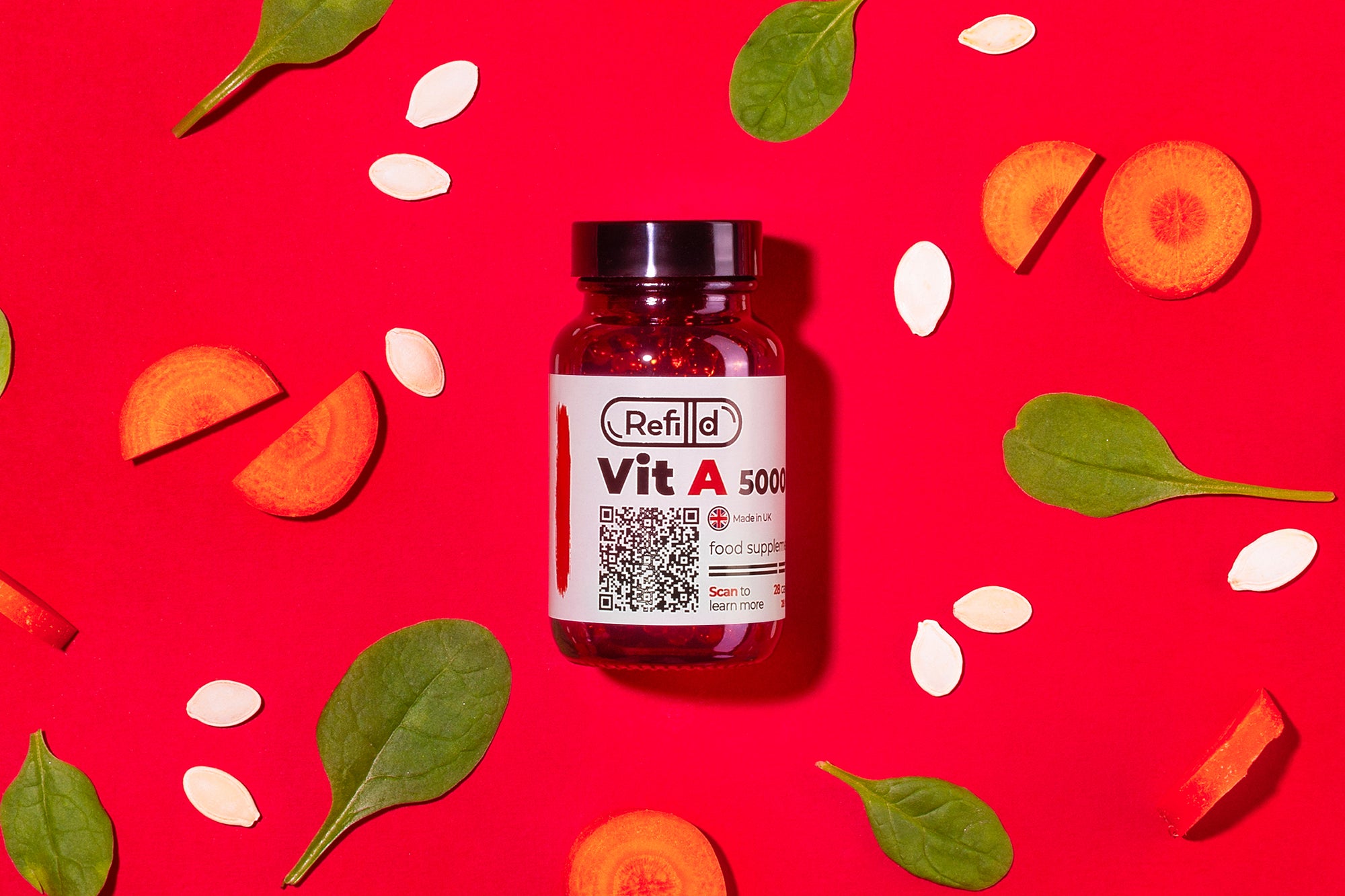 Flat lay of Refilld Vit A 5000 iu food supplement bottle surrounded by fresh vegetables on a red background.
Refilld Vit A, 5000 iu, vitamin A, food supplement, vegetables, red background