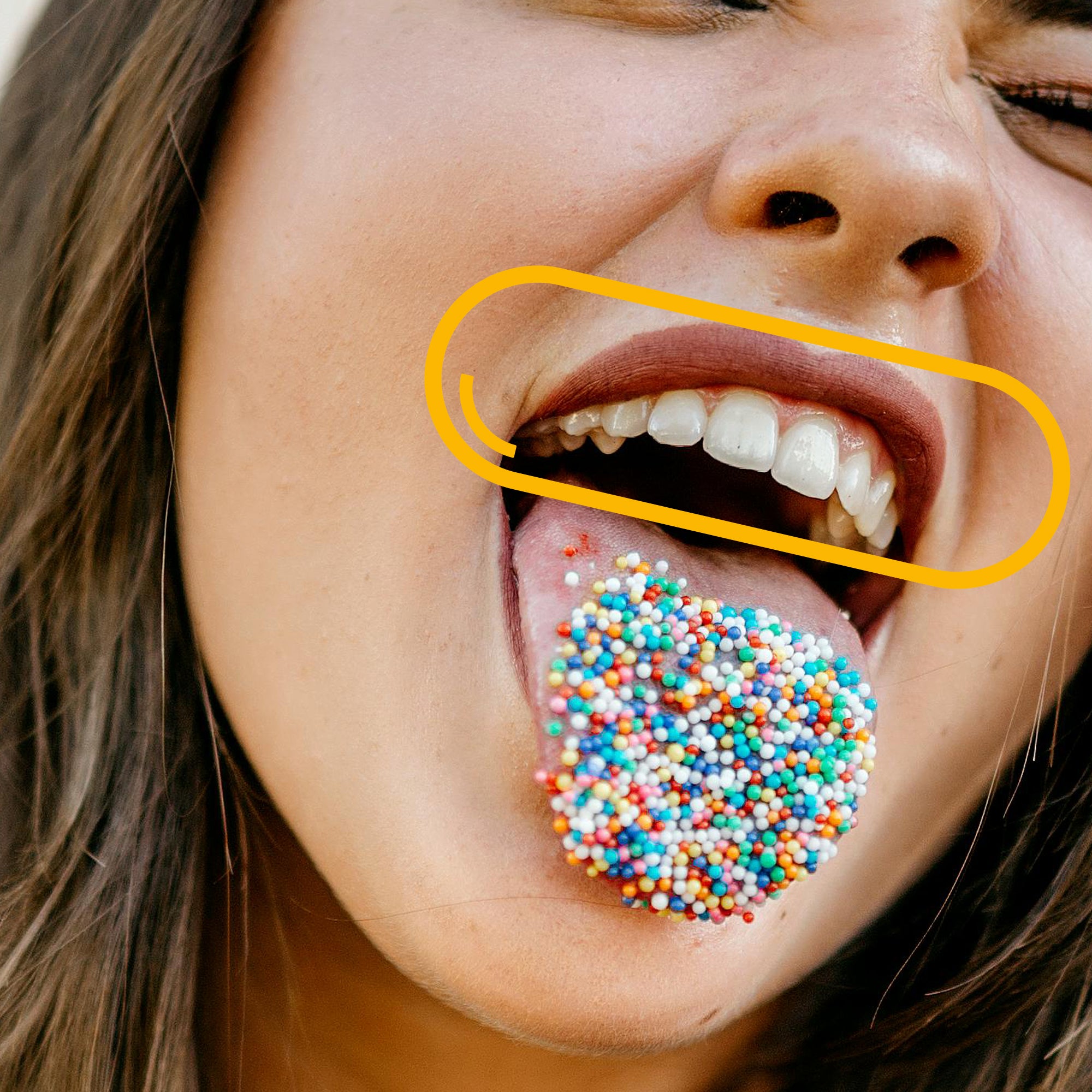 A joyful expression of a person sticking out their tongue covered in colourful sprinkles, representing the fun and vitality associated with Vitamin D3’s benefits for mood and immune support.