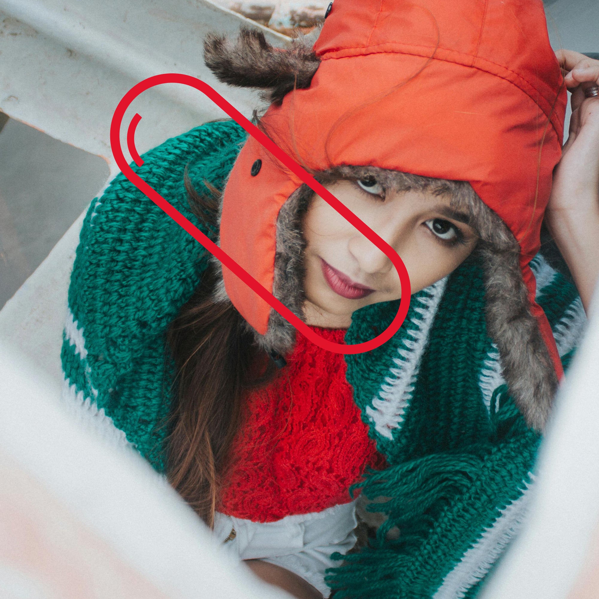 A person dressed in winter clothes with a red hat and green scarf. Vitamin A supports immune function during colder months.